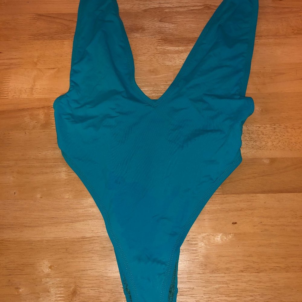 turquoise one piece bathing suit plunge sode boob